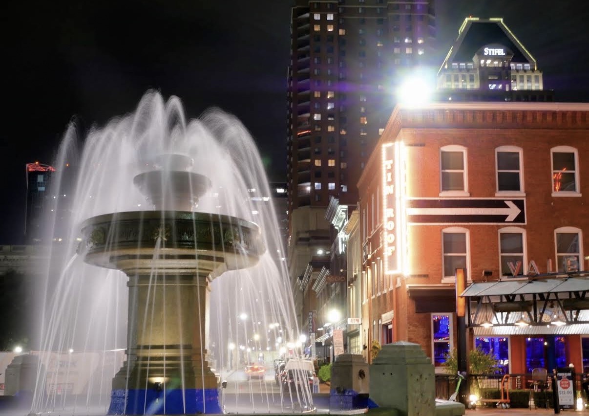 Baltimore's Power Plant district and fountain illuminated at night